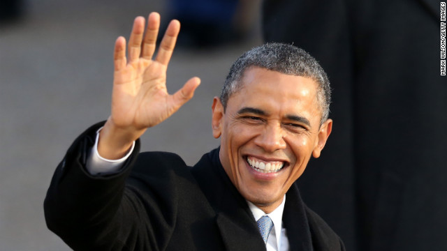 President Obama waves as the presidential inaugural parade winds through the nation's capital on Monday.