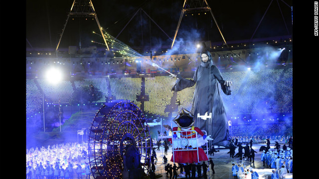 Bonecos gigantes retratando Lord Voldemort, centro, a partir dos livros de Harry Potter eo Catcher Criança de "Chitty Chitty Bang Bang" redemoinho em volta do palco da cerimônia de abertura.